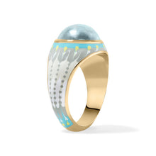 Load image into Gallery viewer, A gold ring with a light blue oval bezel set aquamarine gemstone and a white ty die enamel featuring gray dots and turquoise accents, shown on a white background.